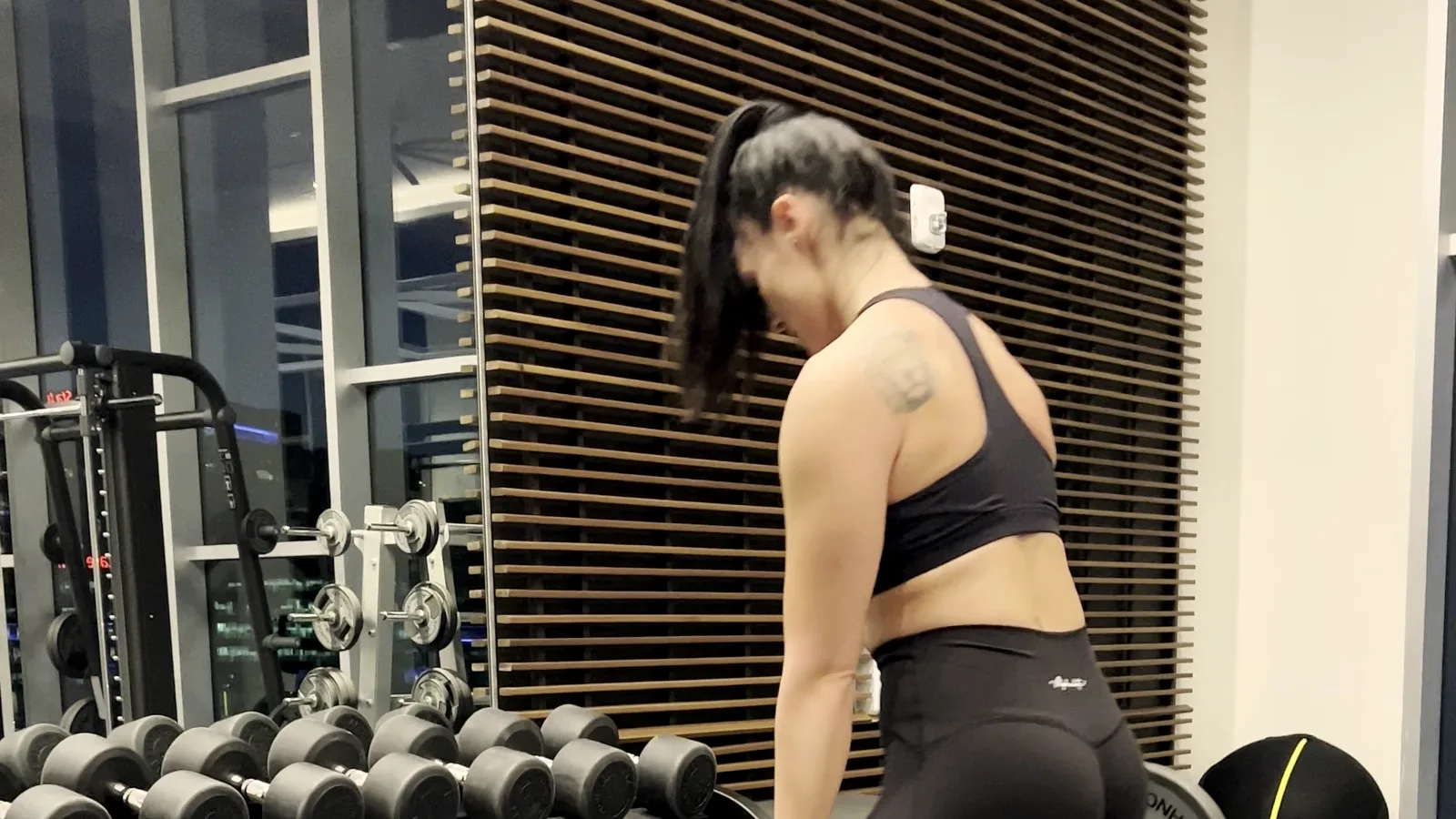 Client mid-setup on a coached barbell hinge
